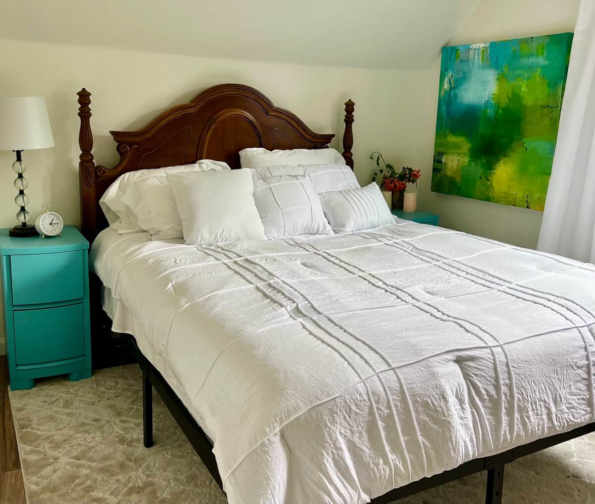 Serene and restful. This queen bedroom features soft linens, a variety of pillows, and peaceful mountain views. On Sundays, you might hear the gentle ring of church bells from just down the street.