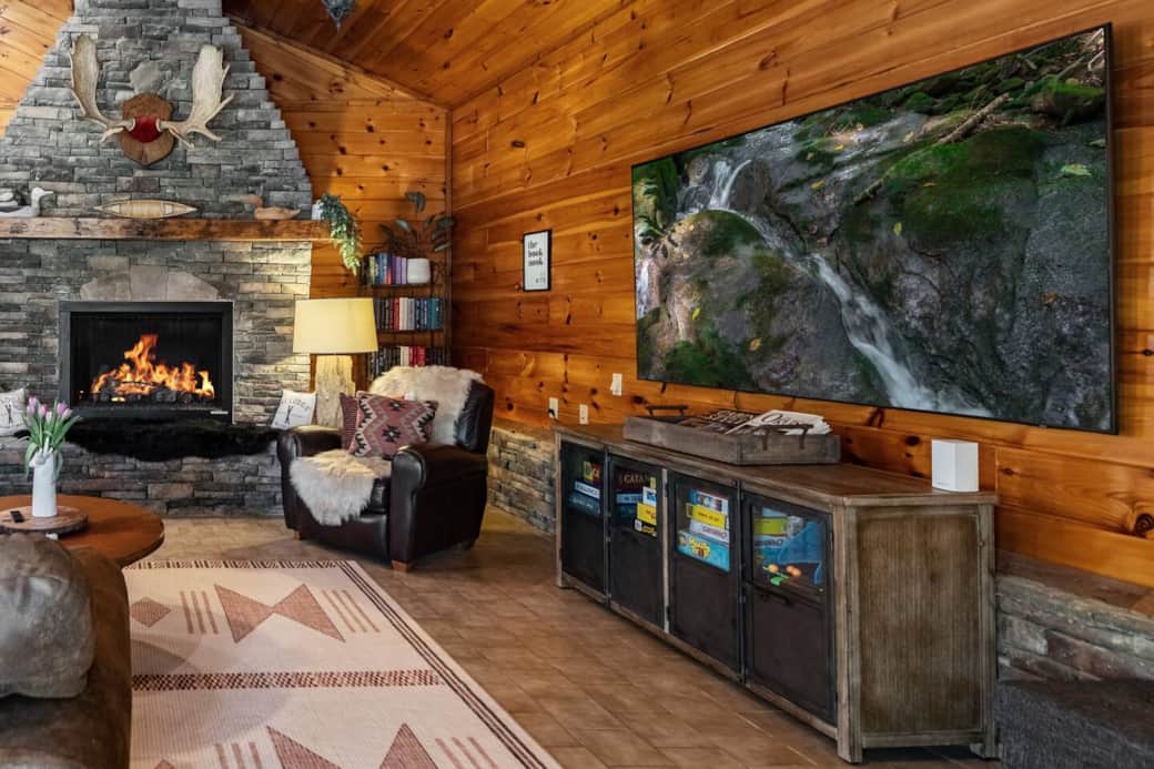 Featuring an 85” Smart TV, 14-foot stone gas log fireplace, and the "book nook" library 