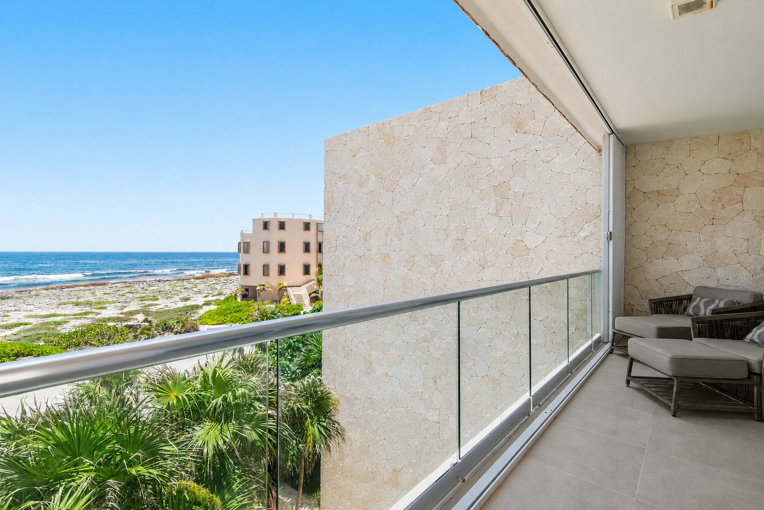 Private balcony with Caribbean Sea views, comfy lounge seating, and the perfect ocean breeze.