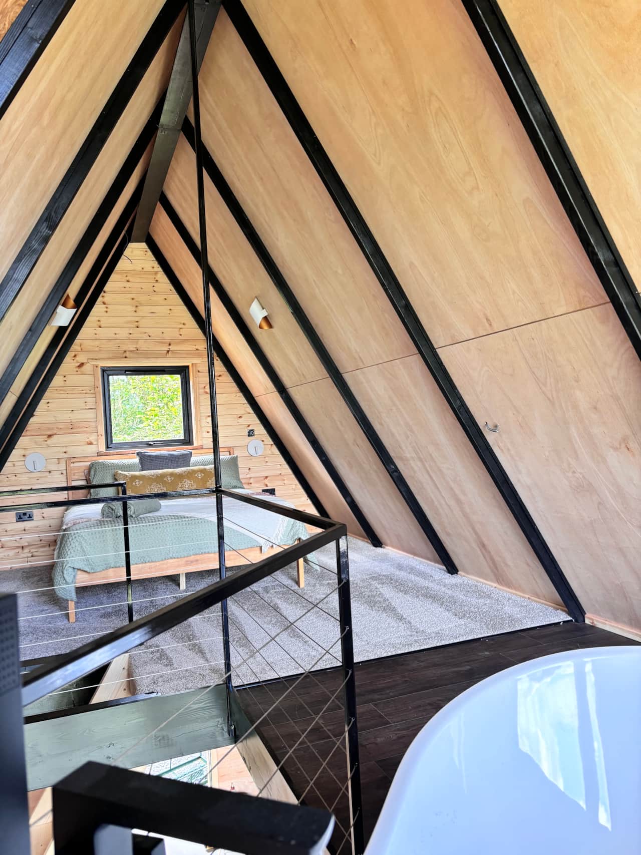 Bedroom loft in Frida Lodge with cosy decor.