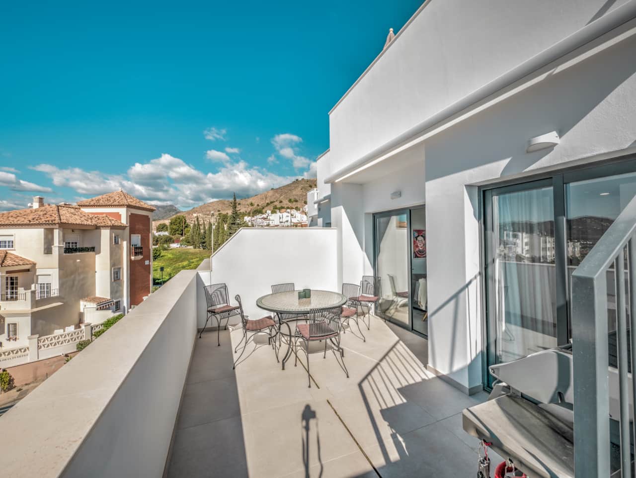 La gran terraza privada con zona de comedor y parrilla para barbacoa.