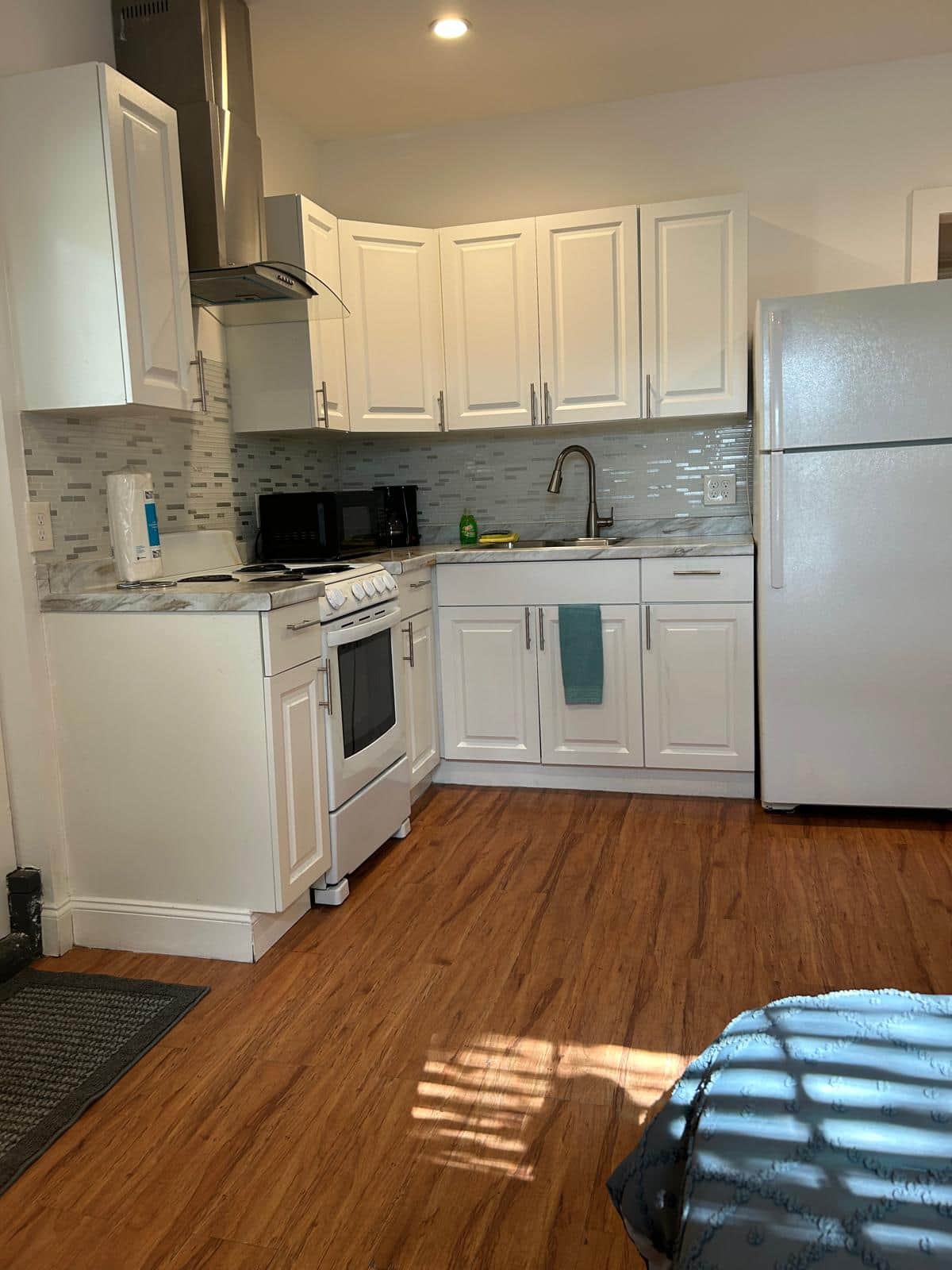 The kitchen is equipped with a refrigerator, coffee maker, and essential amenities. Lakeland, FL