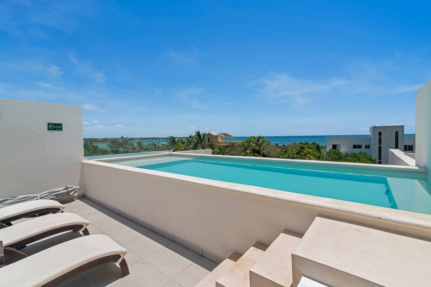 Seven rooftop pools, endless Caribbean ocean views. Lounge in luxury with comfy chairs, shaded umbrellas, and convenient bathrooms just steps away.