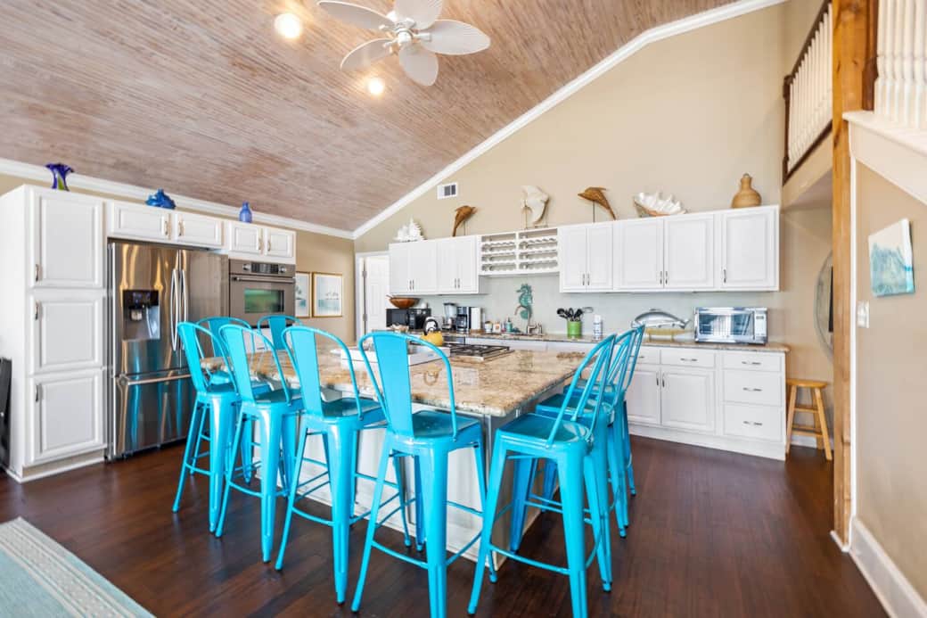 Oversized granite island provides a great spot to share a meal with your group.