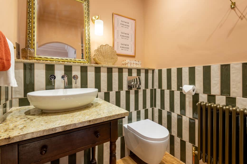 Step into a serene bathroom sanctuary featuring a luxurious waterfall shower.