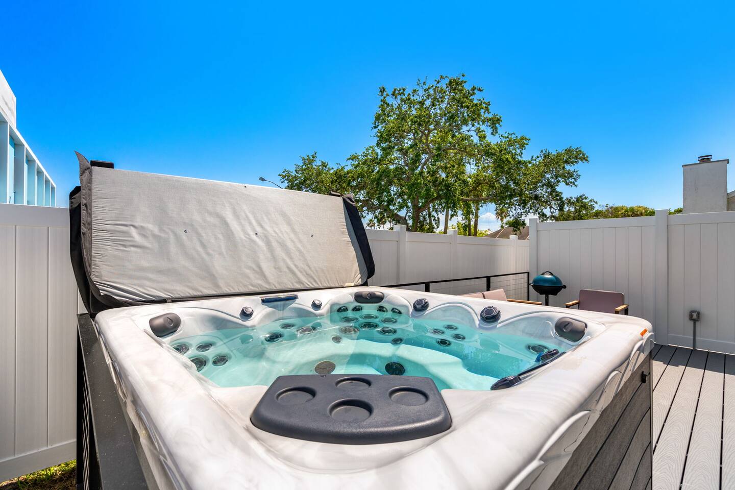 Relax in the hot tub with a view of the clear sky and surroundings.