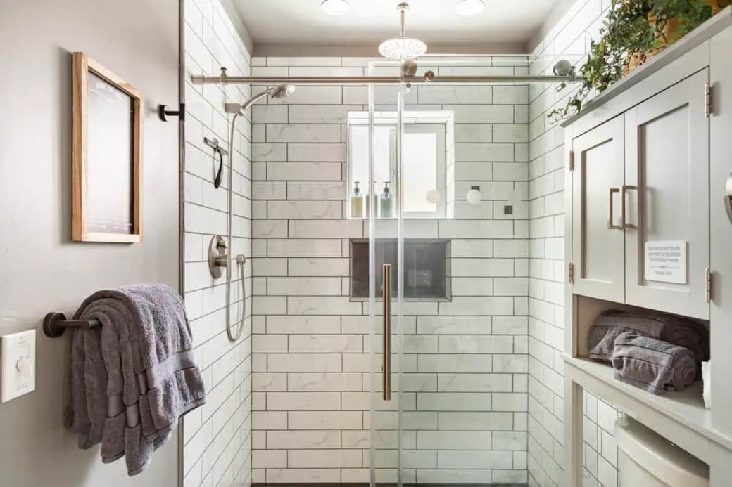 Heated bathroom with a walk-in shower with dual shower heads Heated bathroom with a walk-in shower with dual shower heads