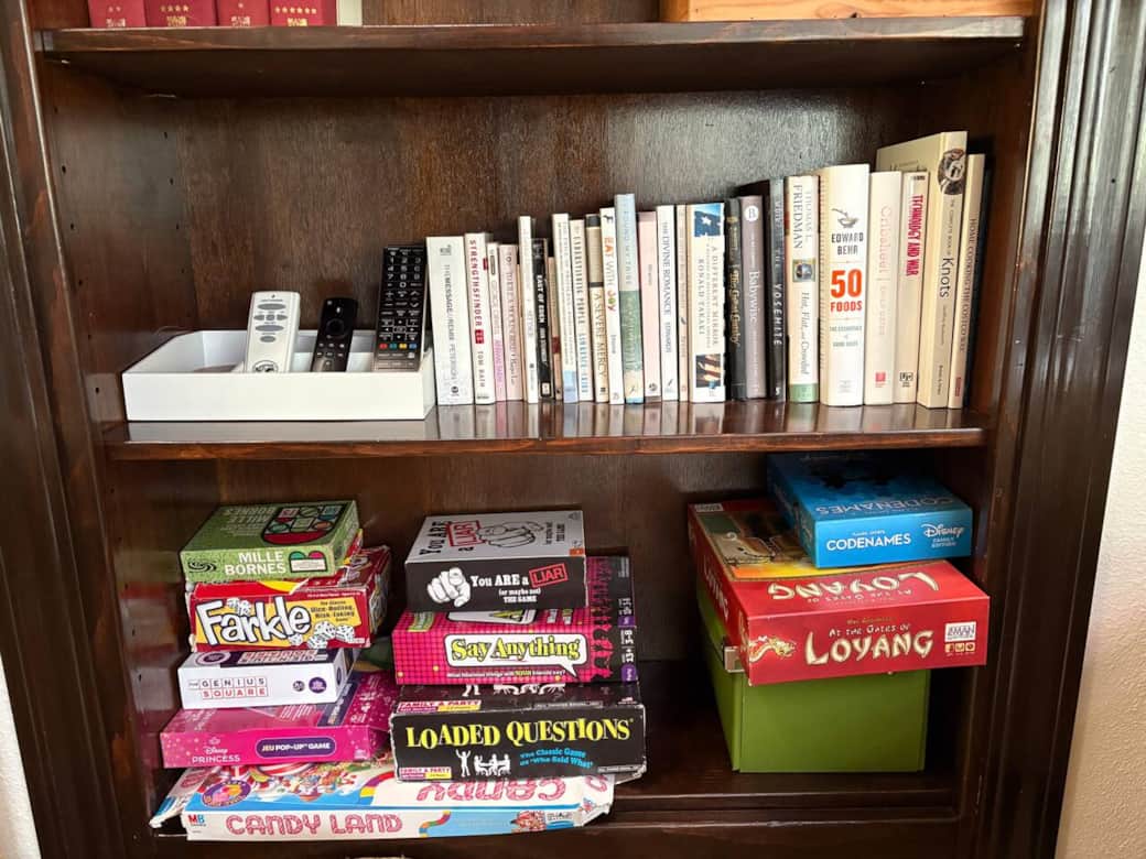 Game shelf stocked with favorites: Loaded Questions, Candy Land, Say Anything, and party games. Perfect for family game nights or rainy day entertainment.