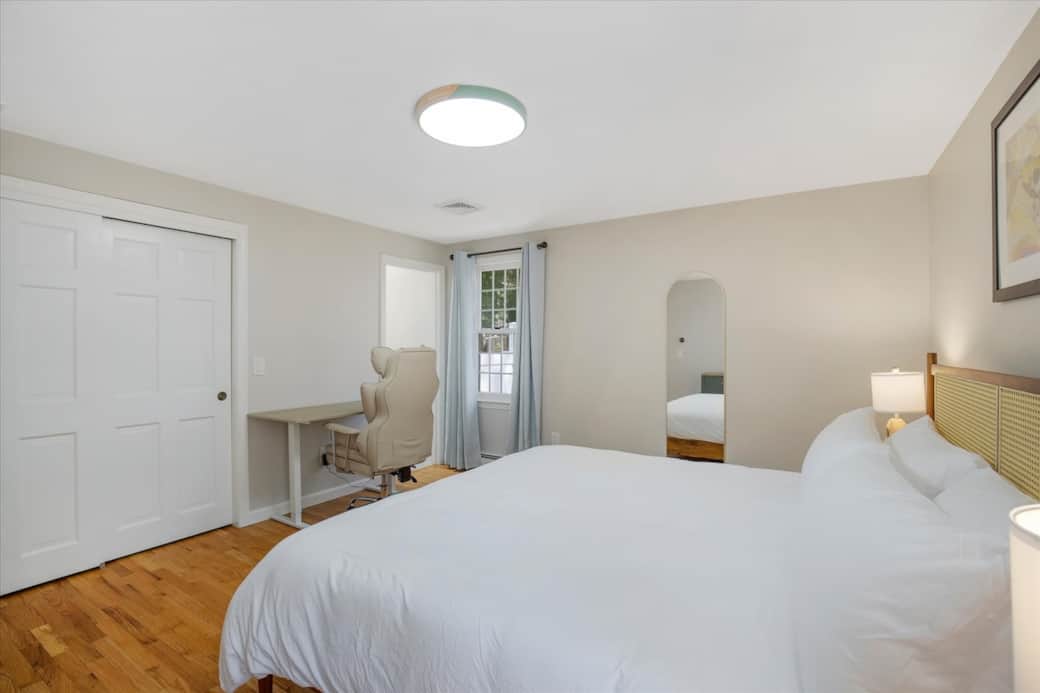 Primary bedroom — bright and airy with hardwood floors