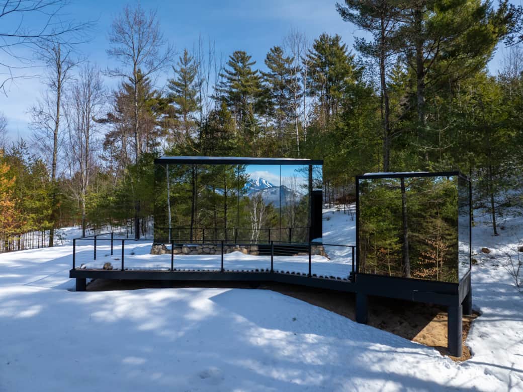 ÖÖD Whiteface at Jay exterior glass reflecting Whiteface Mountain ski trails, with sauna off deck
