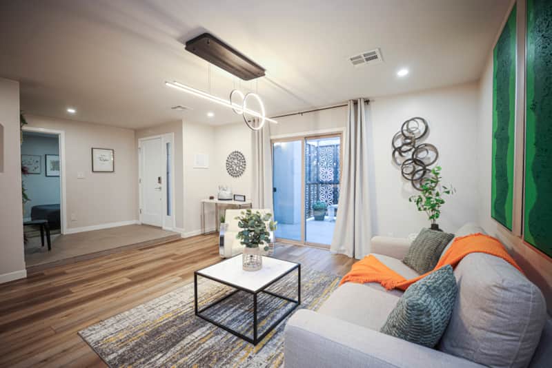 Front living room with comfortable seating and green artwork.