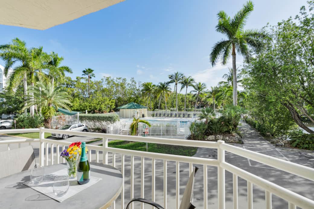 Private balcony overlooking the pool, palms, and tropical walking paths. Private balcony overlooking the pool, palms, and tropical walking paths.