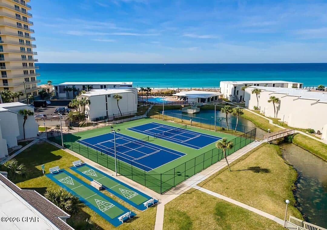 Tennis/pickle ball courts, shuffleboard and walking path around pond