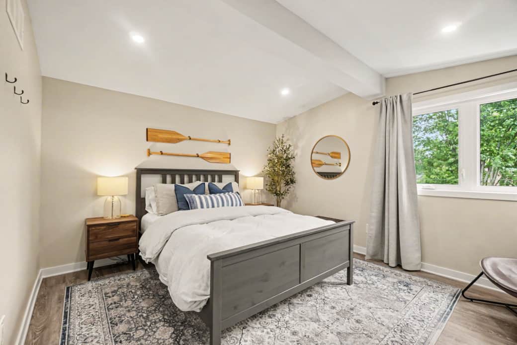 Bright, cozy primary bedroom featuring a plush queen-size bed, modern neutral decor, and plenty of n Bright, cozy primary bedroom featuring a plush queen-size bed, modern neutral decor, and plenty of n