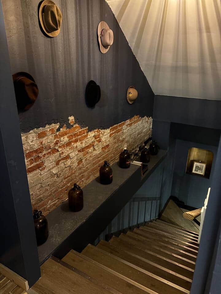 Hidden speakeasy door opens up basement with unique historical elements -building used to sell hats