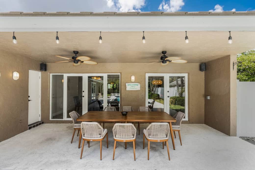 Experience the stunning view of our beautiful backyard oasis from our relaxing patio, complete with a large table for gatherings and ceiling fans to beat the Florida sun.