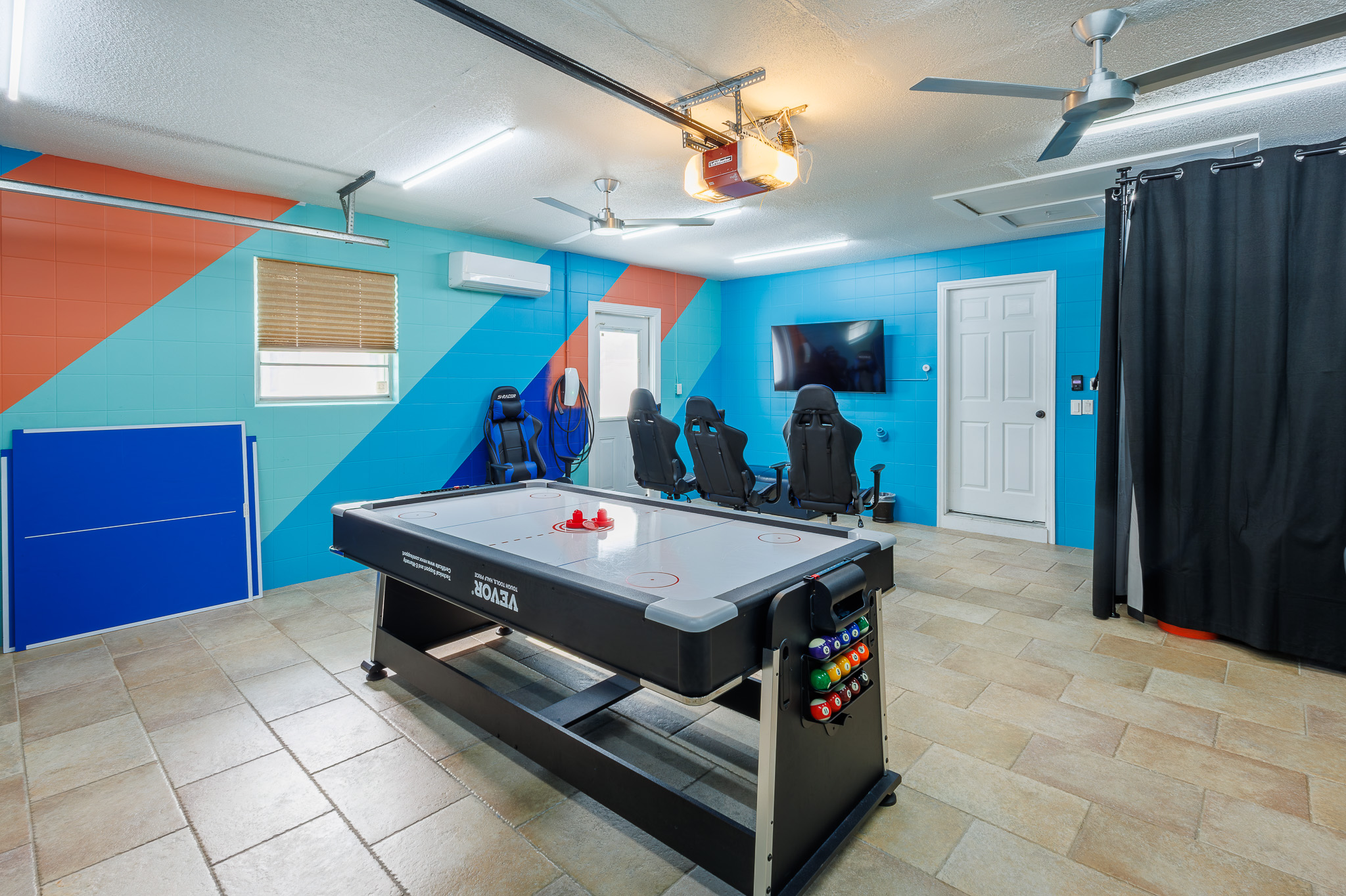 Challenge your friends to a game of air hockey in this vibrant game room.