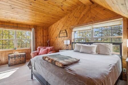 King-sized bed and large windows in the sleeping loft.