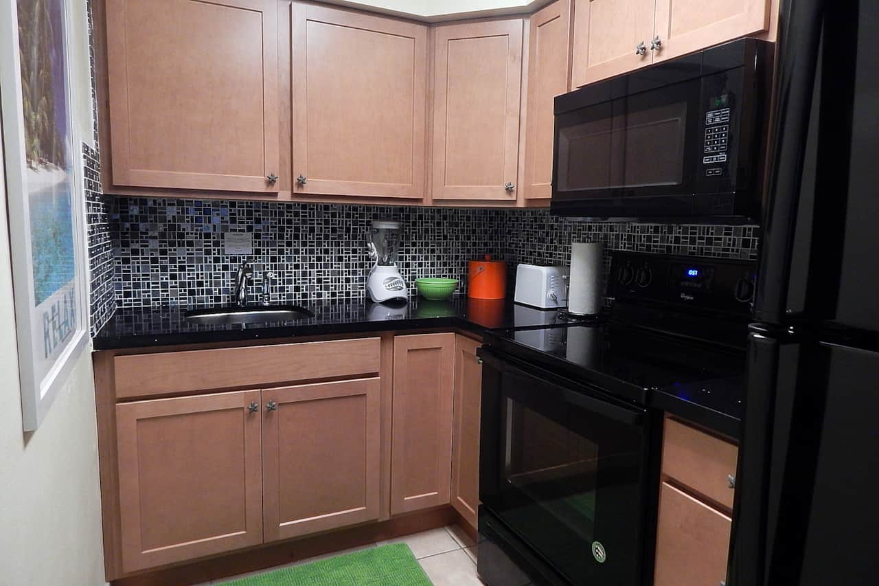 Unit #28 Kitchen stocked with everything you need to cook and serve meals.