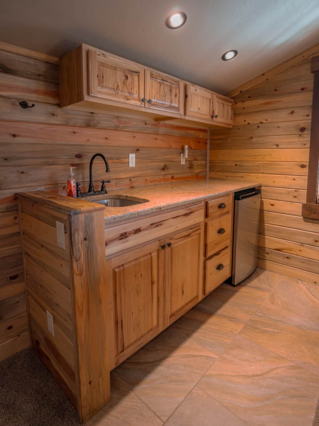 Upstairs kitchenette featuring a sink and mini fridge. Upstairs kitchenette featuring a sink and mini fridge.