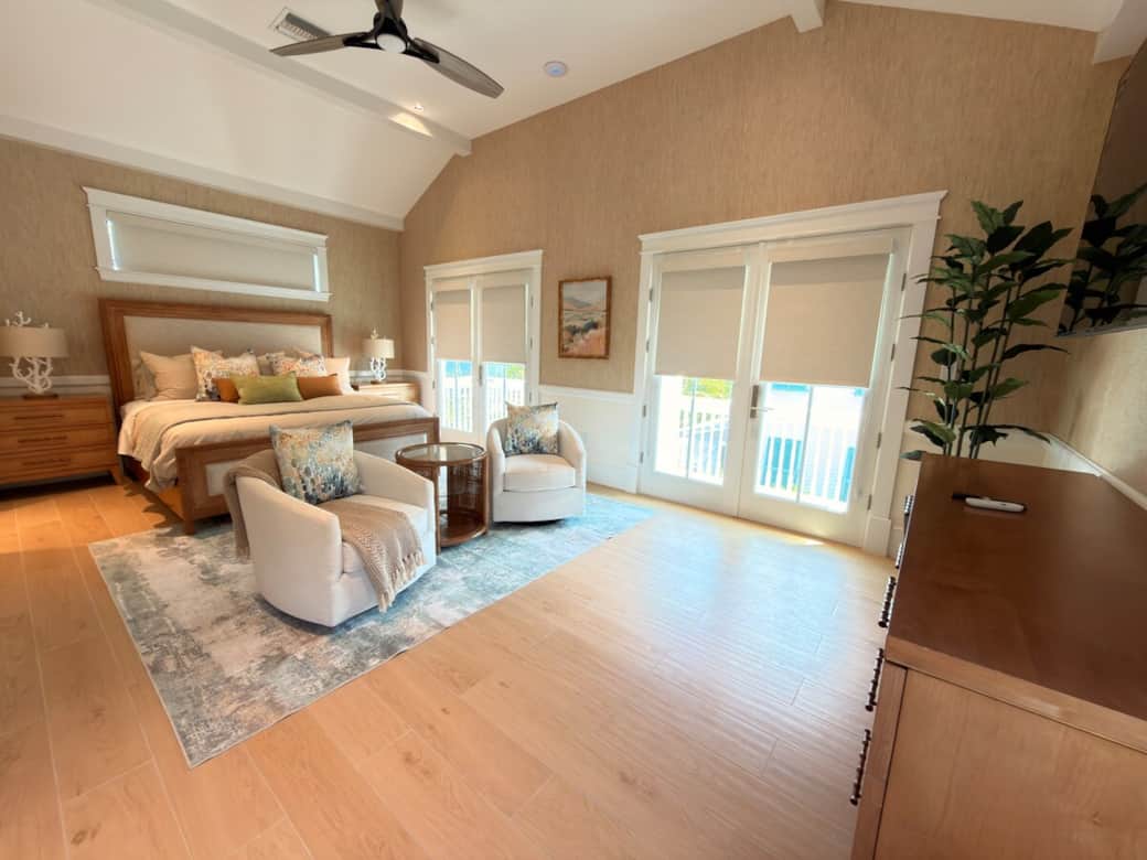 Spacious primary suite with king bed, en-suite bath, and private balcony overlooking the pool.