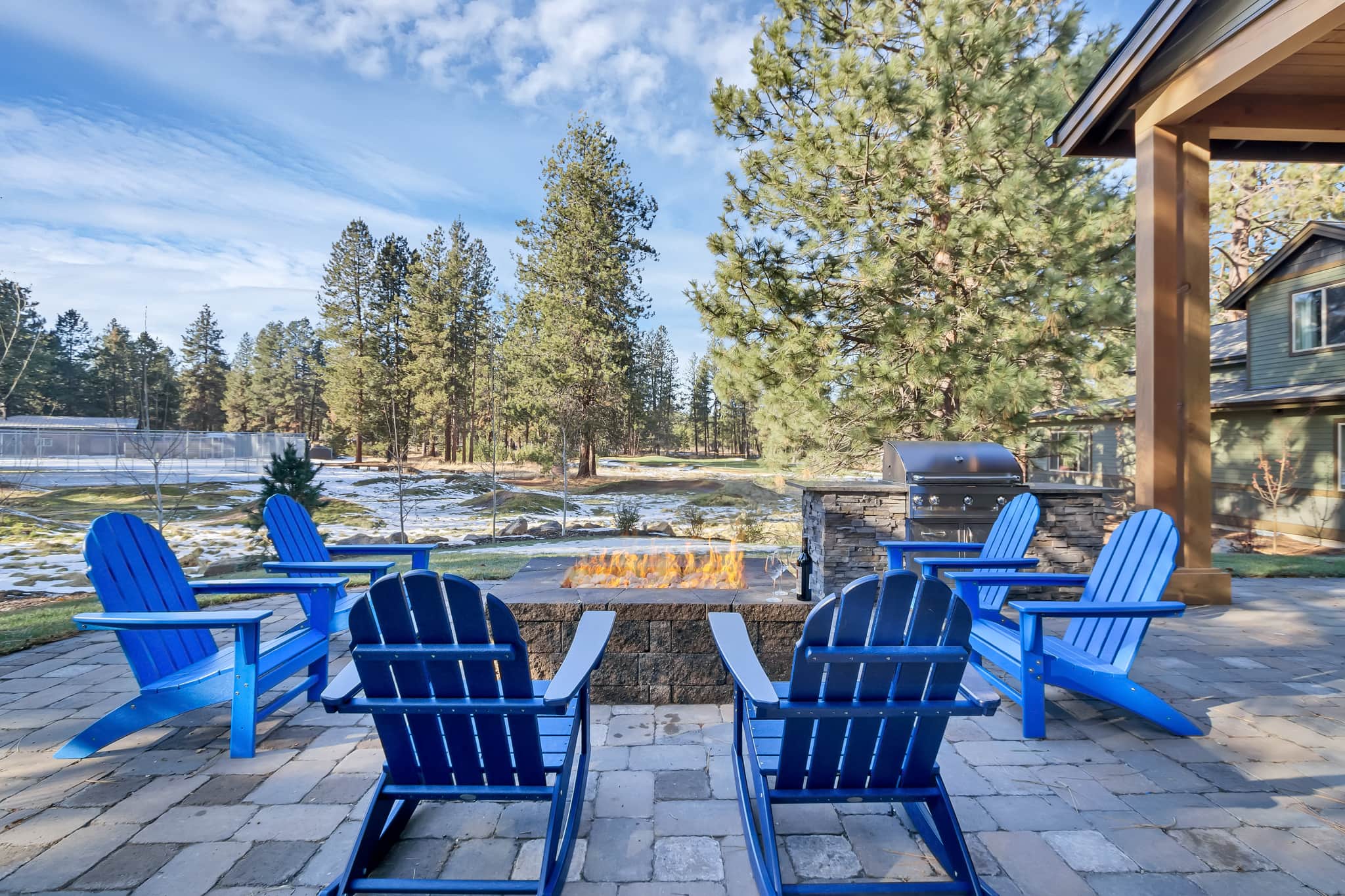 Fire pit and Adirondack chairs at dusk