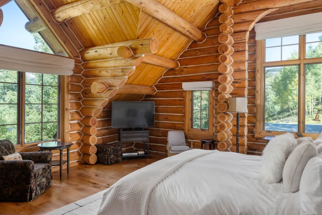Upstairs primary suite with king bed and windows facing every direction. Upgraded linens.