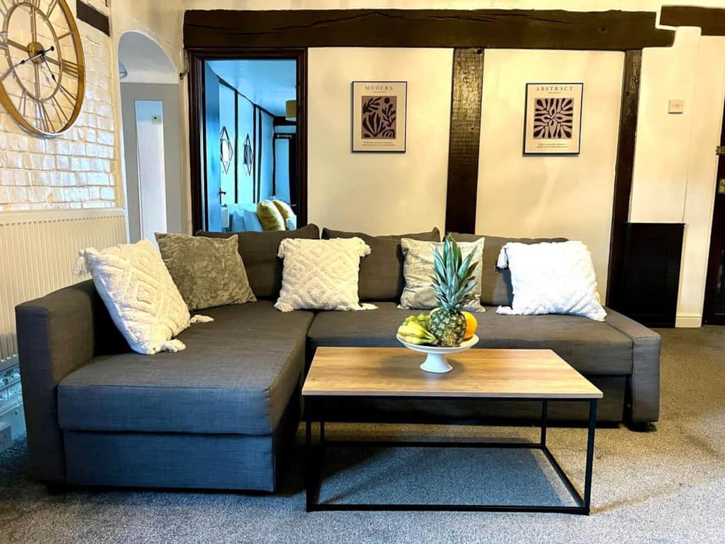 Spacious and cozy living room perfect for relaxation and entertainment. Book your stay tod