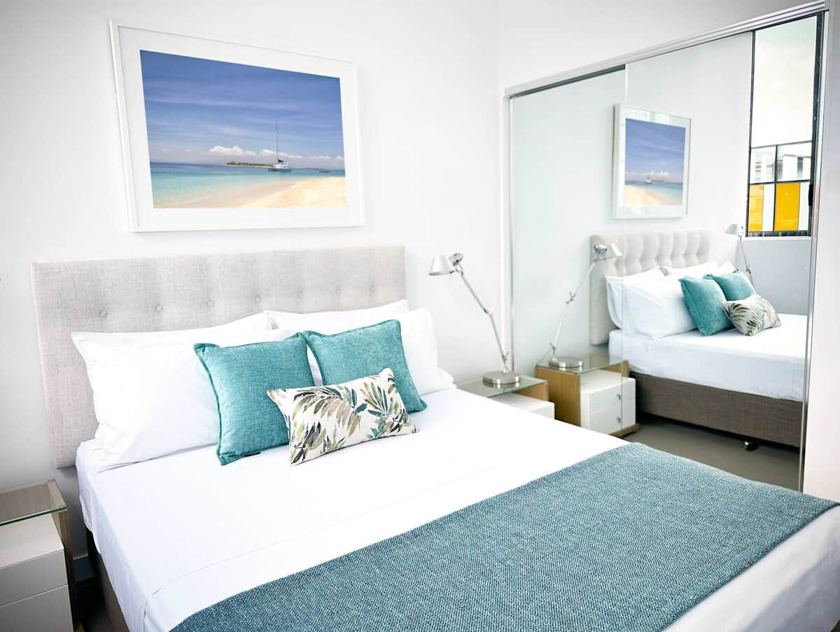 Blackout blinds + queen bed with premium linens for a great night's sleep.