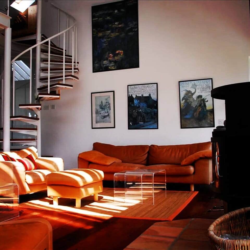 Inviting living room with a traditional wood-burning stove — gather for cozy evenings at Anam Arís.