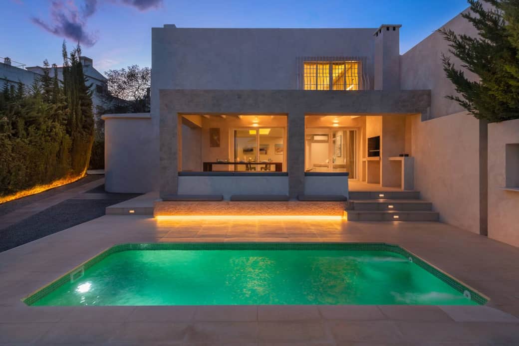 Night pictures of the villa living-dining, terrace, and pool area.