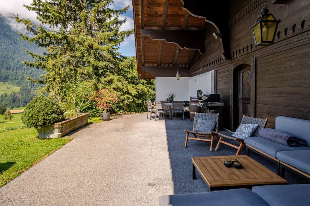 Our outdoor space features a spacious covered terrace, protected from the elements, complete with comfortable lounge seating, a granite dining table, a barbecue grill, and extra sun covers.