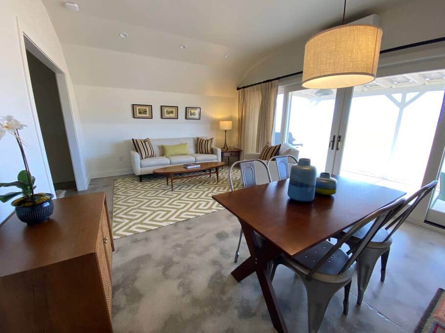Living room and dining table with views of mountains