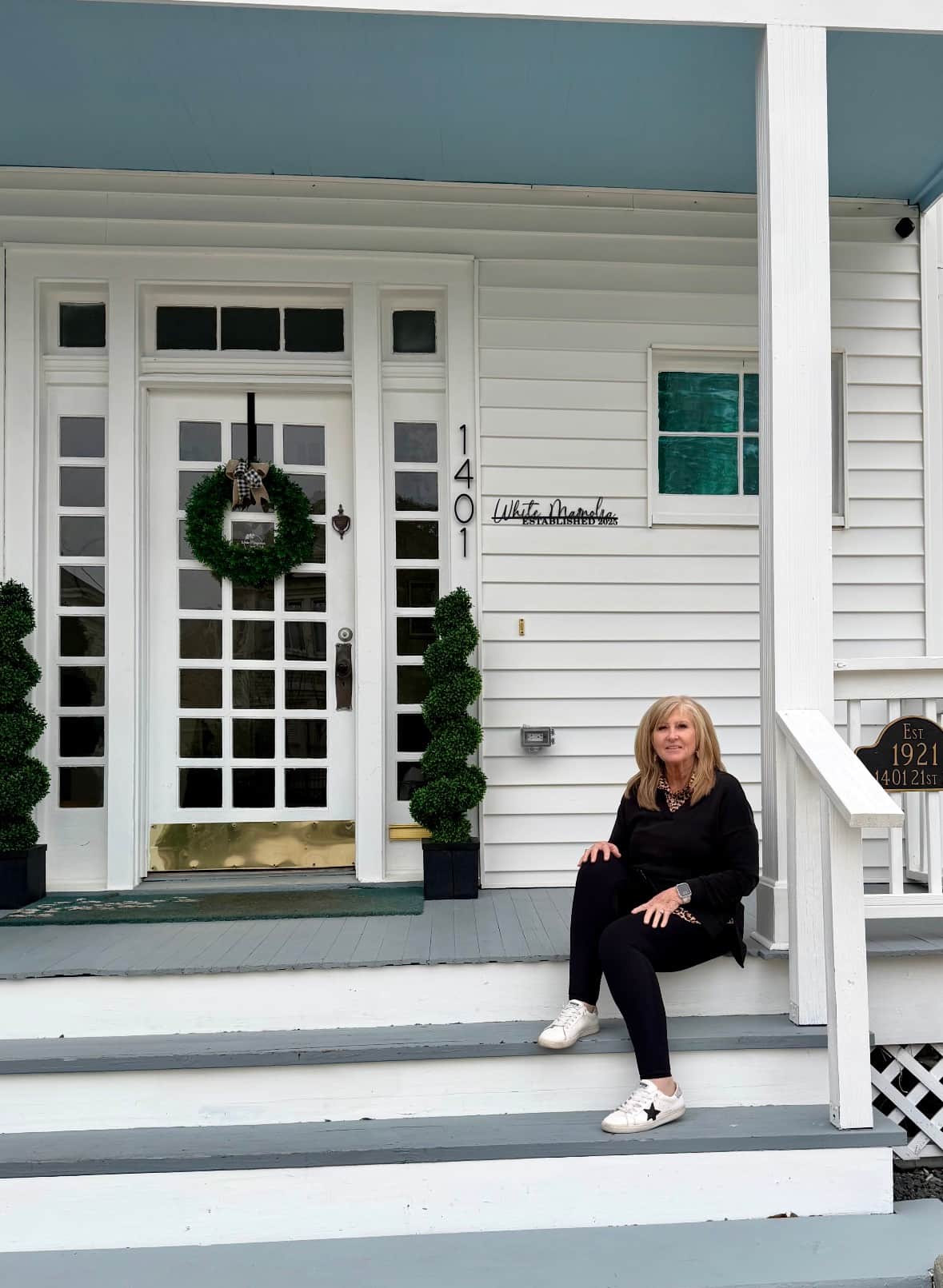 Guest sitting on the front steps at White Magnolia Galveston in the historic East End