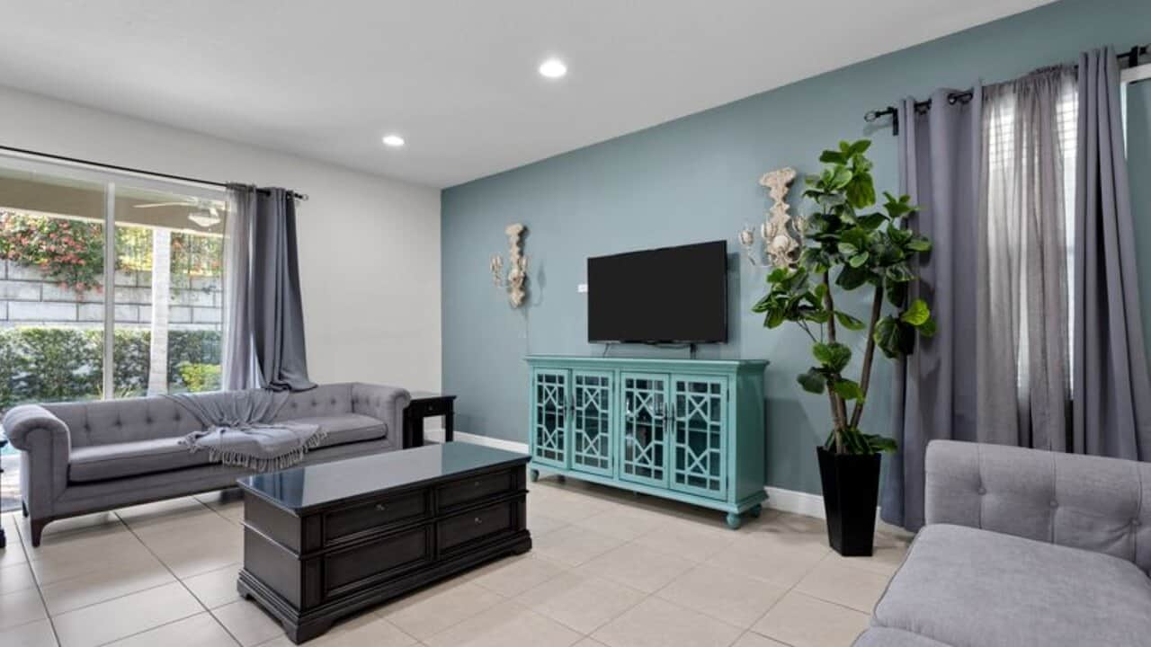 - Bright sitting room with comfortable sofas and a Smart TV