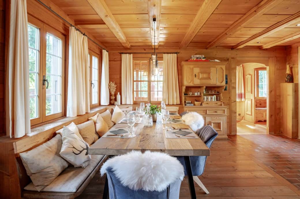 Experience the charm of our rustic dining and living space, featuring a magnificent oak table and a cozy corner bench that seats up to 10 people, all beside a warm, inviting fireplace.