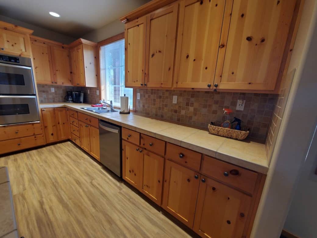 Kitchen sink and dishwasher with view of the territory. Tons of counter space.