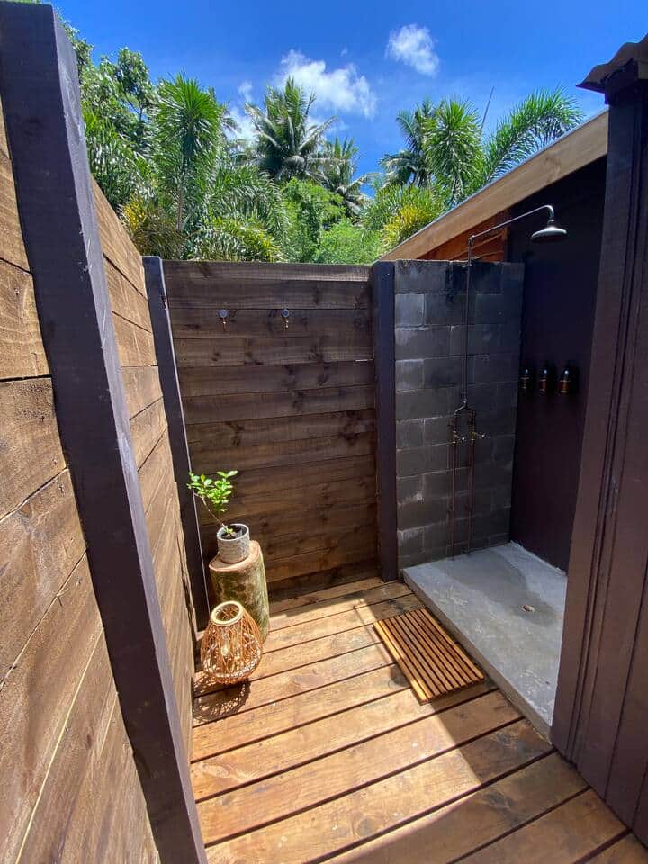 An outdoor shower awaits you, stocked with shampoo, conditioner and body-wash.