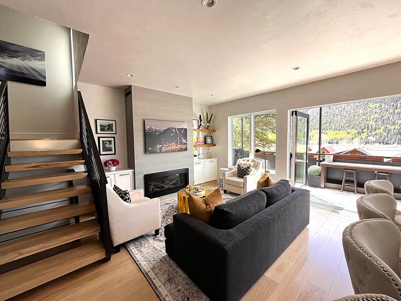 Living room with plenty of light, gas fireplace, TV (behind art lift) and comfortable seating