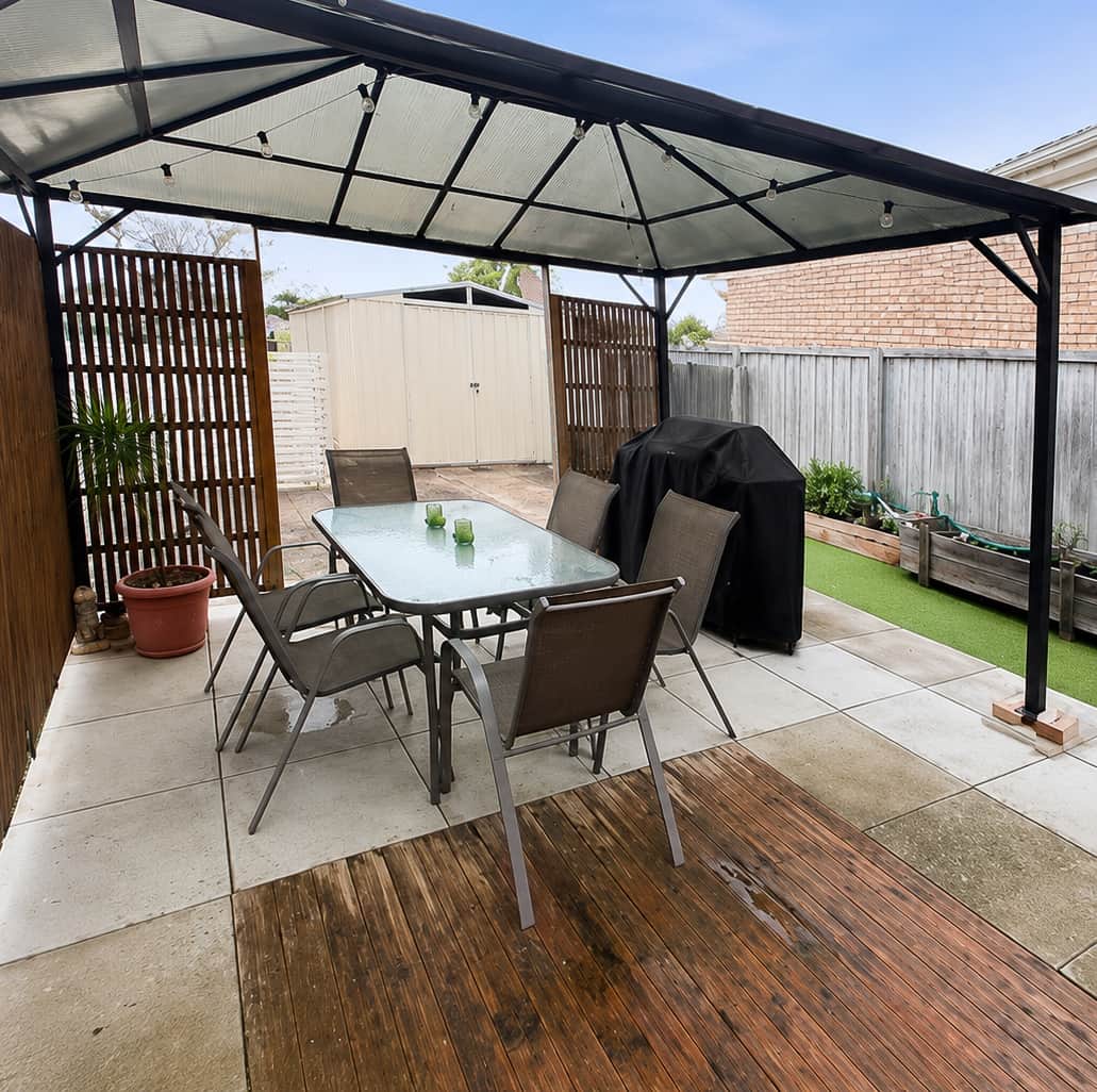 Enjoy private outdoor dining with a BBQ, pizza oven, and covered entertaining area
