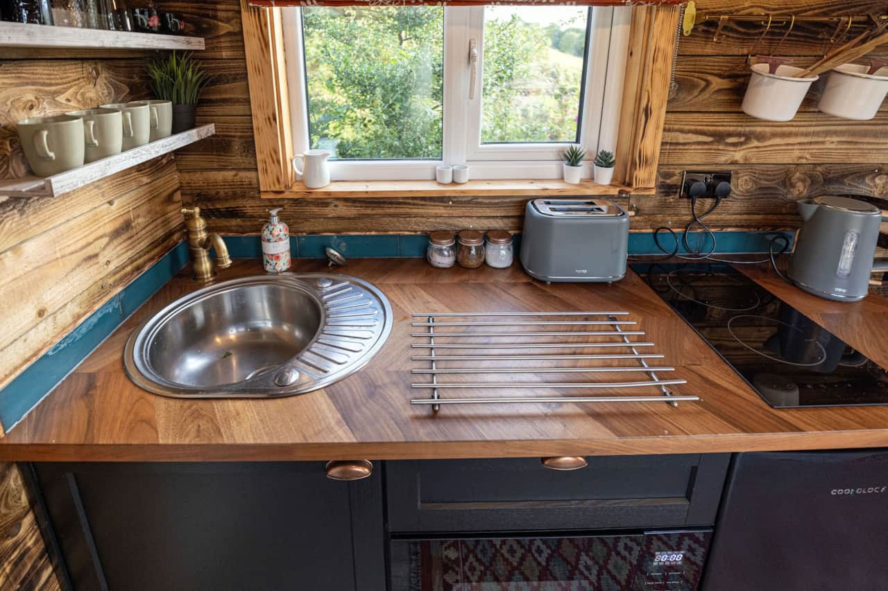 Compact kitchen area with sink and modern amenities.