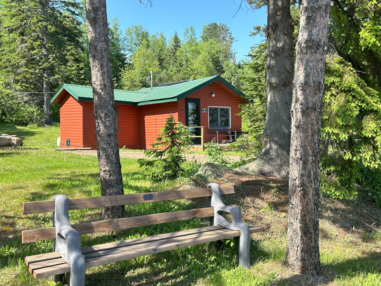Eve's Place Cabin 3 with Eve's memorial bench in foreground. 