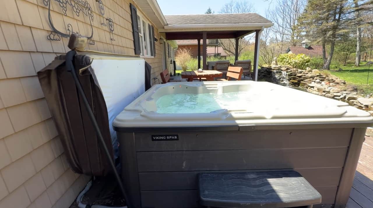 Relax in the hot tub with a view of the fire pit and sounds of the waterfall.
