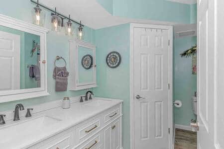 Newly updated master bathroom featuring double vanity sinks and shower with glass door!