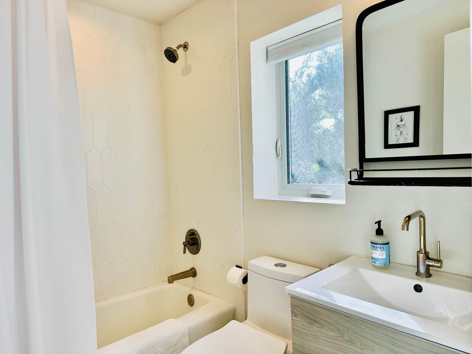 Renovated Unit 1 bathroom at Casa Citron with new fixtures, upgraded lighting, and a brighter interio