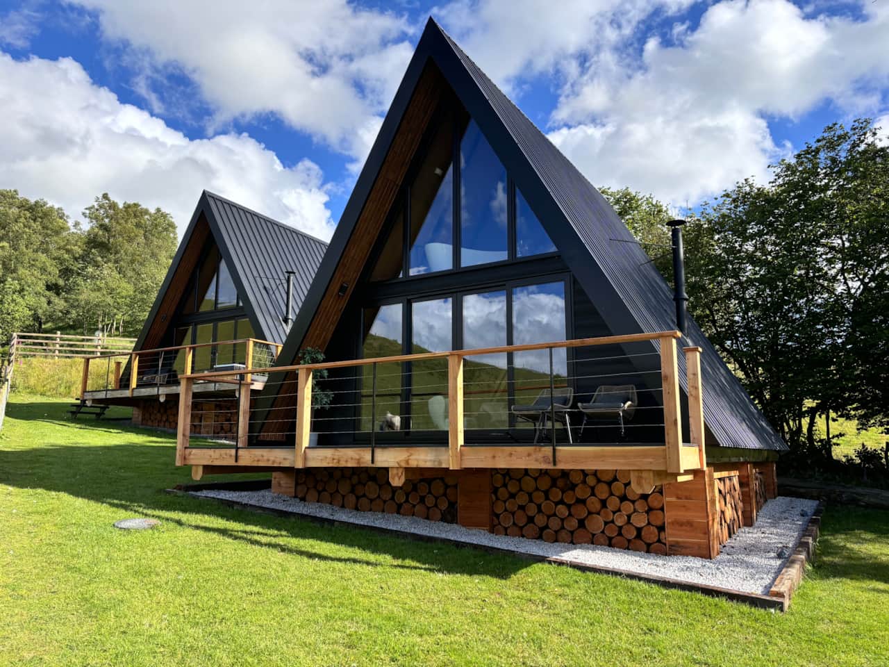 A-frame design with wood accents and deck.