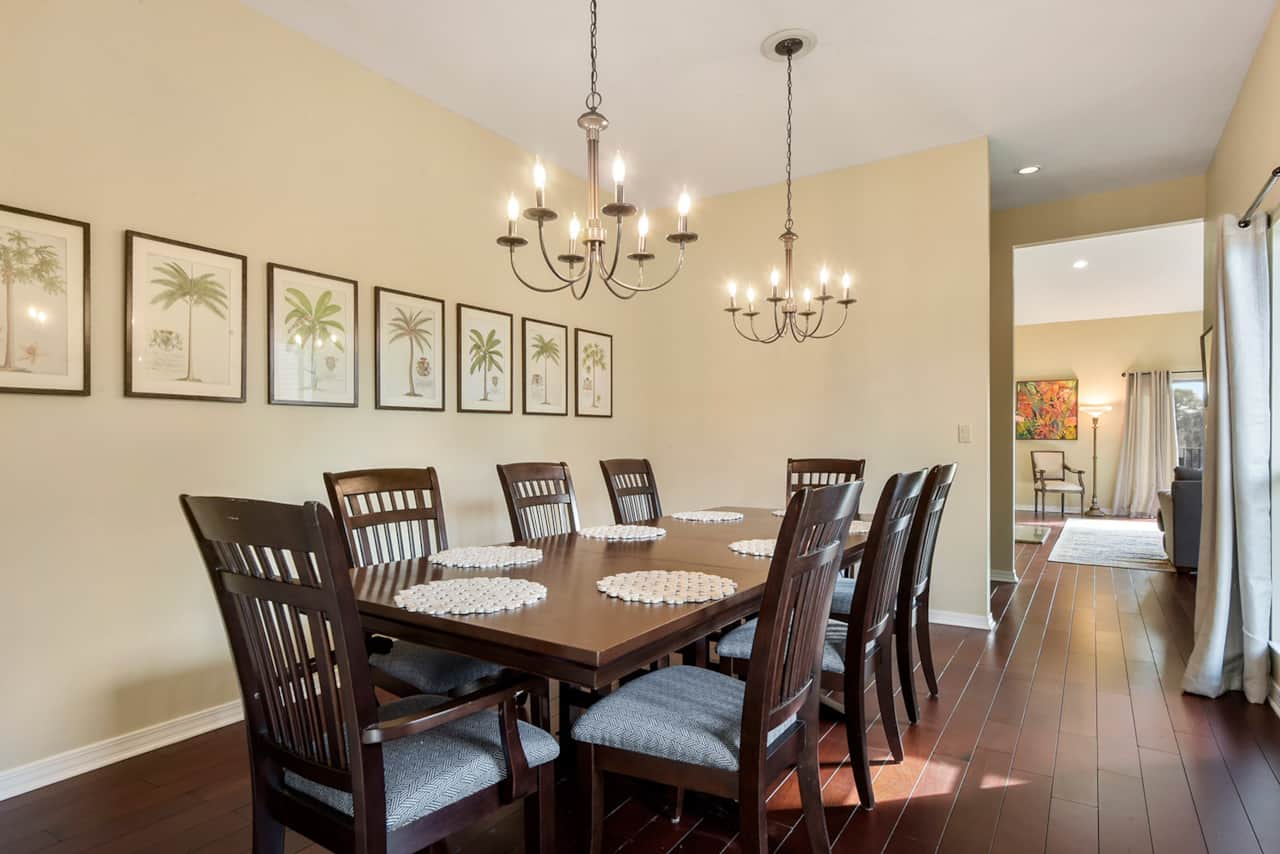 Dining room with a large table that seats 8 guests. 