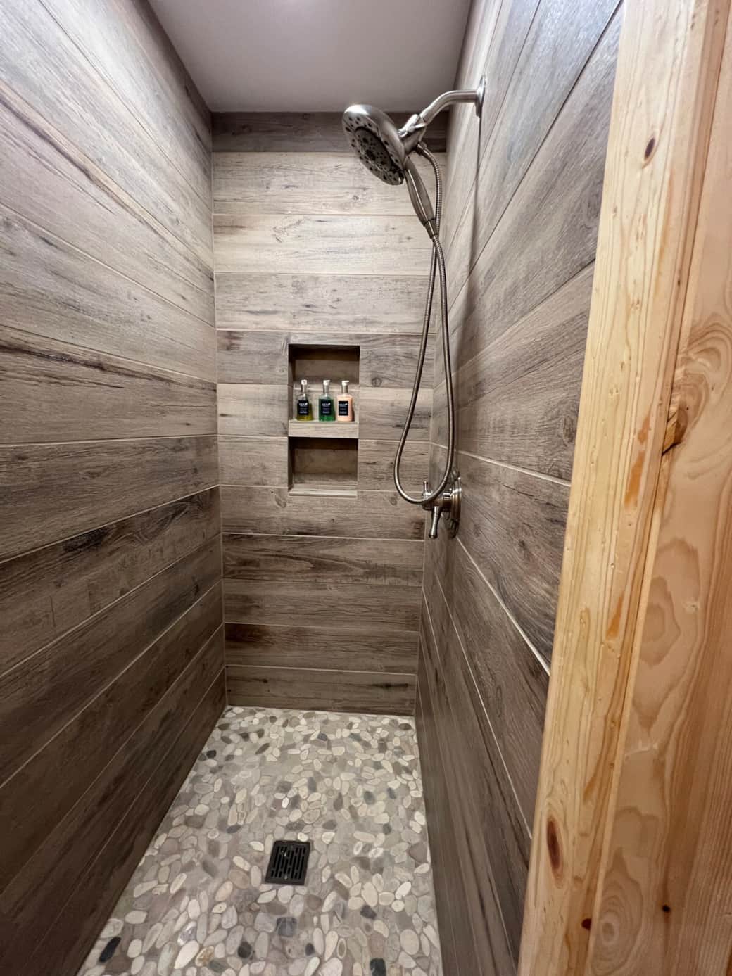 New Tile Shower with pebble floor and fantastic shower head with removable handle! Shampoo, Conditioner, and Body Soap! 