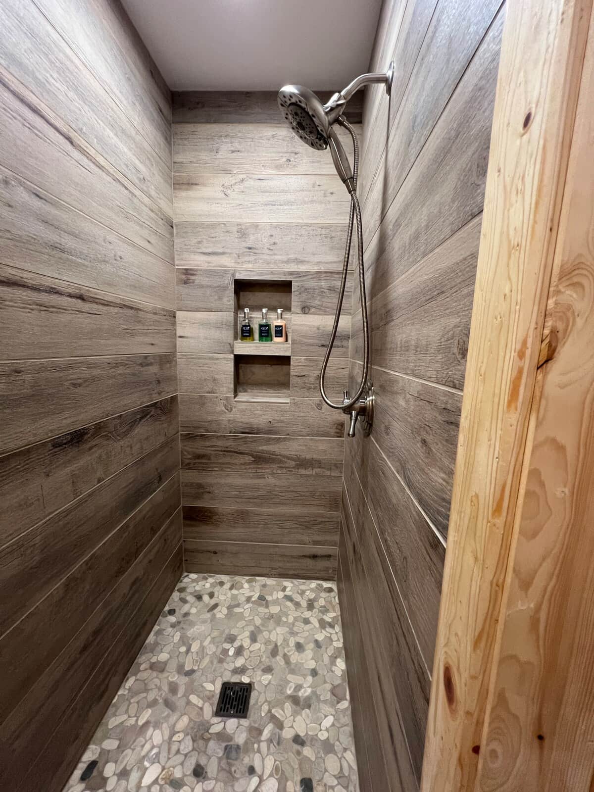 New Tile Shower with pebble floor and fantastic shower head with removable handle! Shampoo, Conditioner, and Body Soap! 
