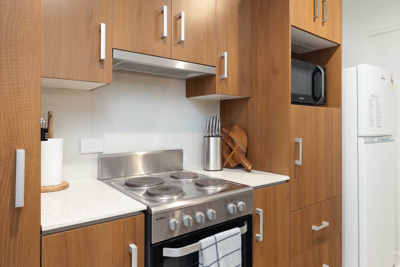Kitchen: Sleek kitchen with ample storage, modern appliances 